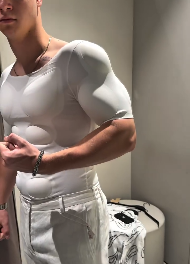 Wearer flexing an arm in the V-Core compression shirt